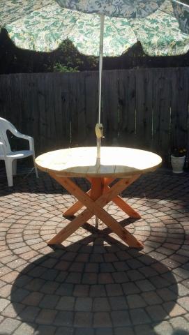 Round picnic table with umbrella (not included)